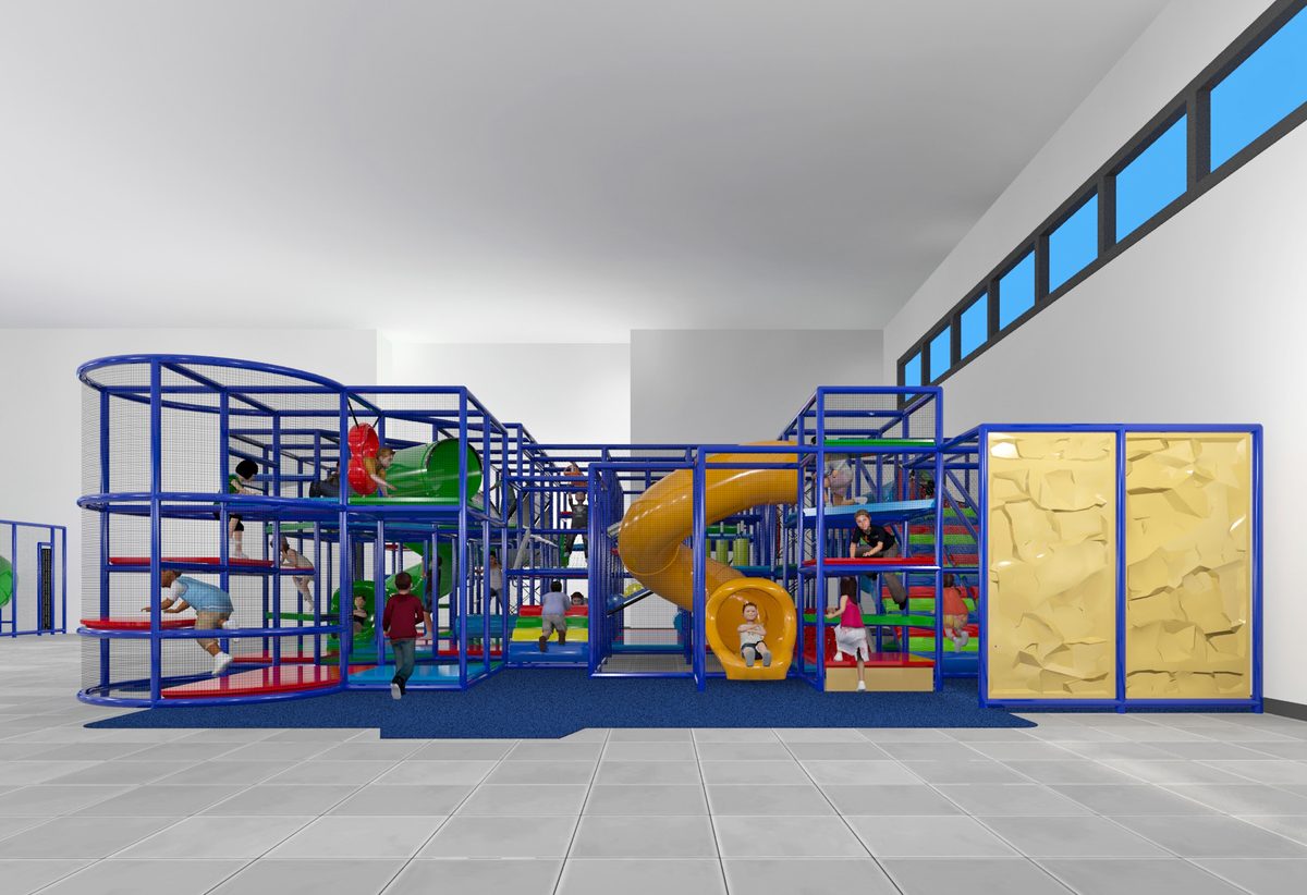 The play tower with a yellow slide and climbing wall